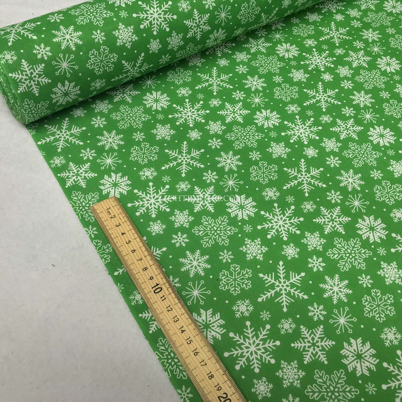 Tissu polycoton de Noël flocons de neige congelés, vert