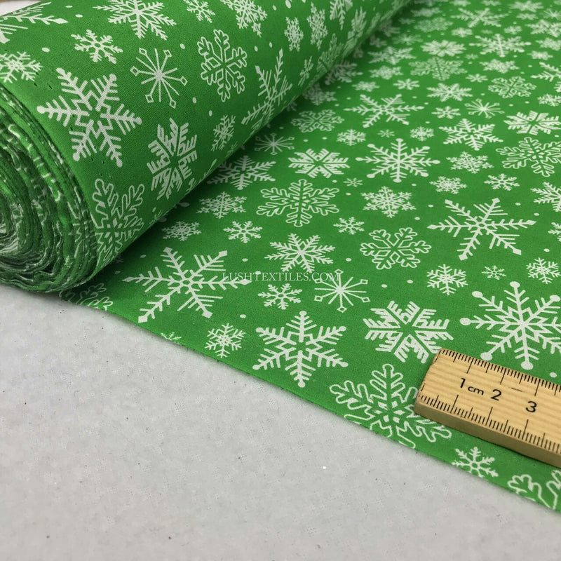 Tissu polycoton de Noël flocons de neige congelés, vert